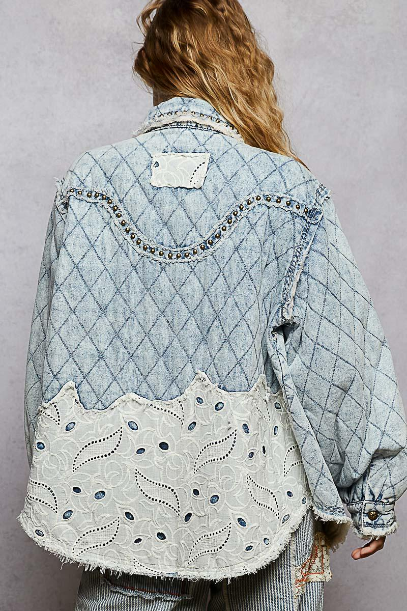 Angled view of the raw, frayed hem and diamond-quilted pattern on a boho denim outerwear piece