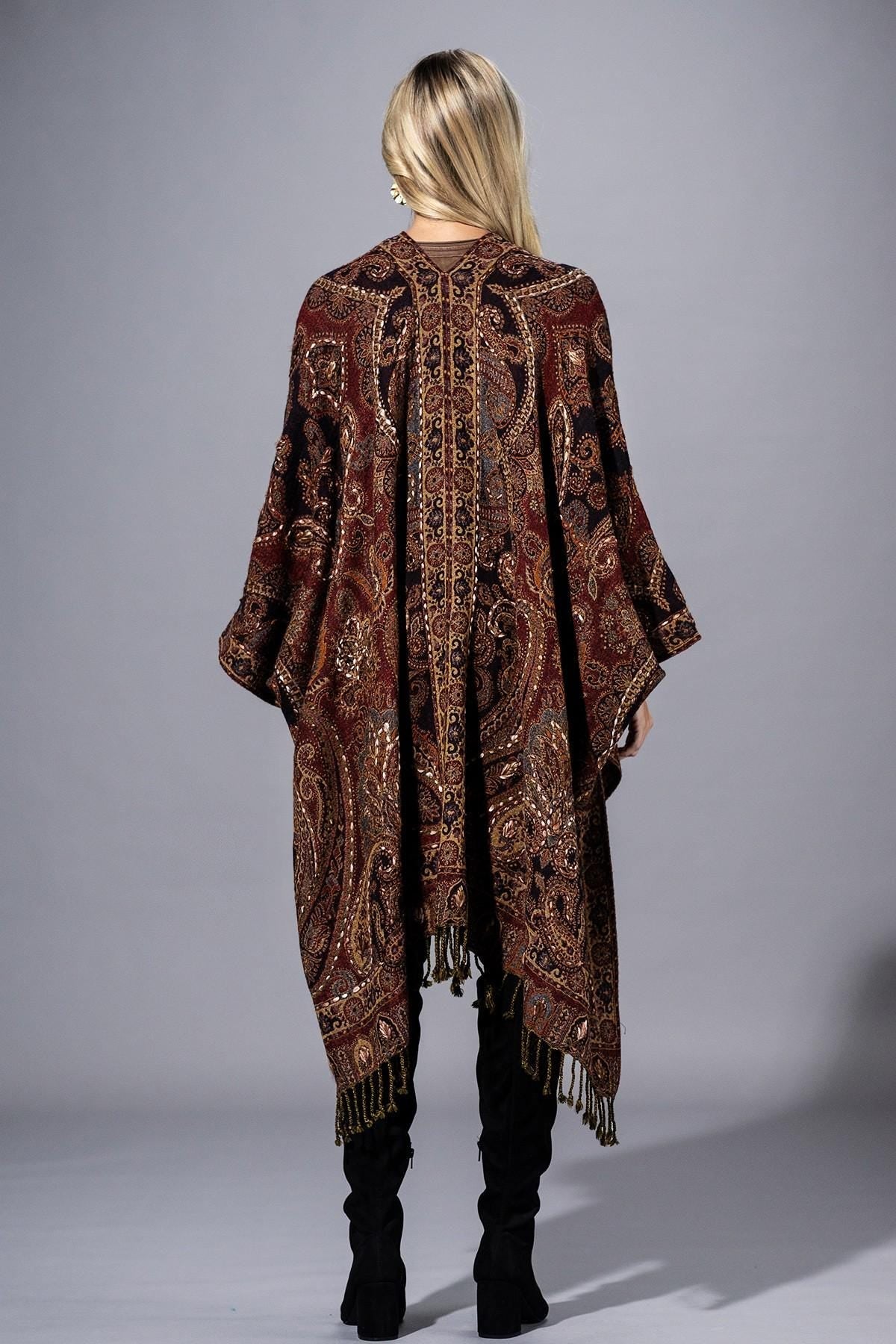 Flat lay of the deep burgundy artisanal-chic wool poncho highlighting the bronze paisley motif