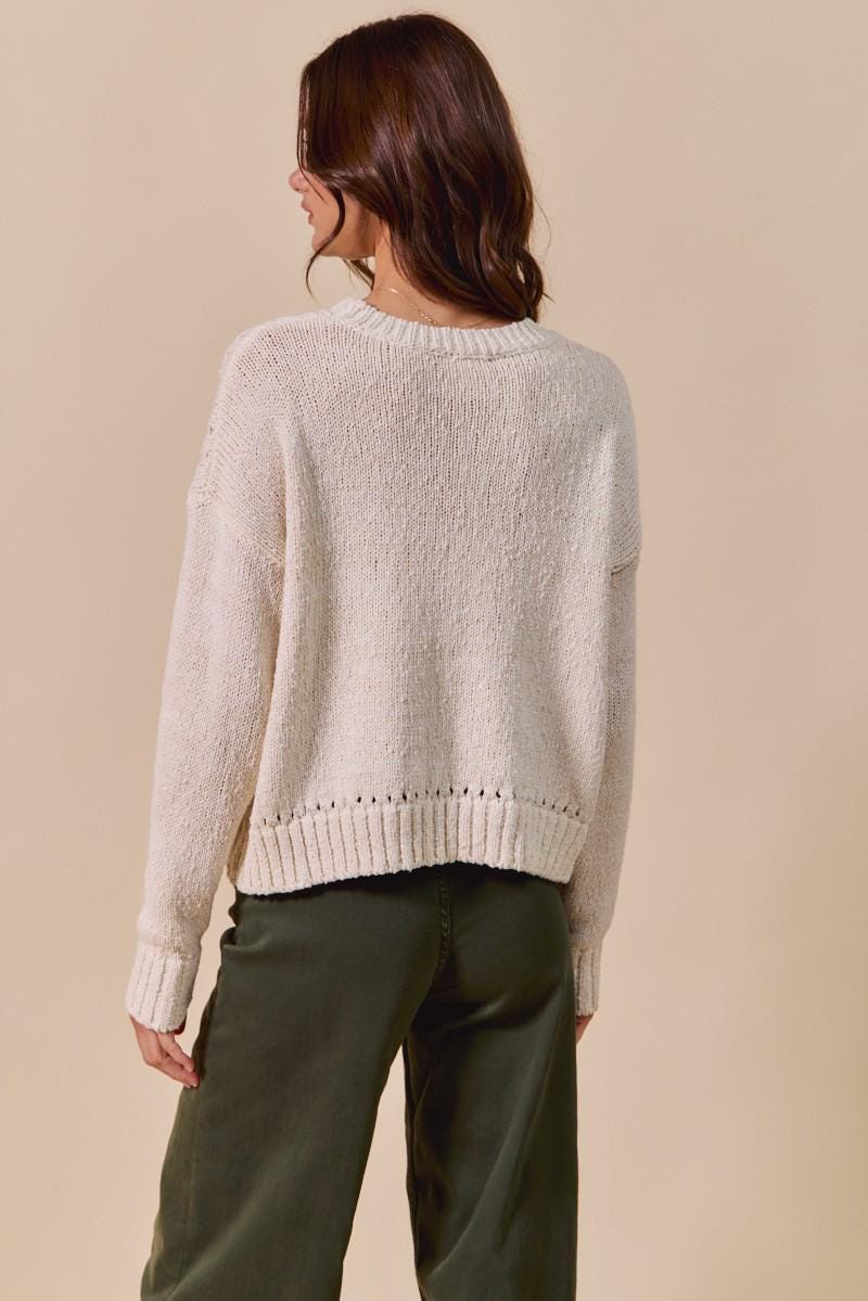 Flat lay of the boho-chic tomato graphic sweater showing the full design and whimsical aesthetic