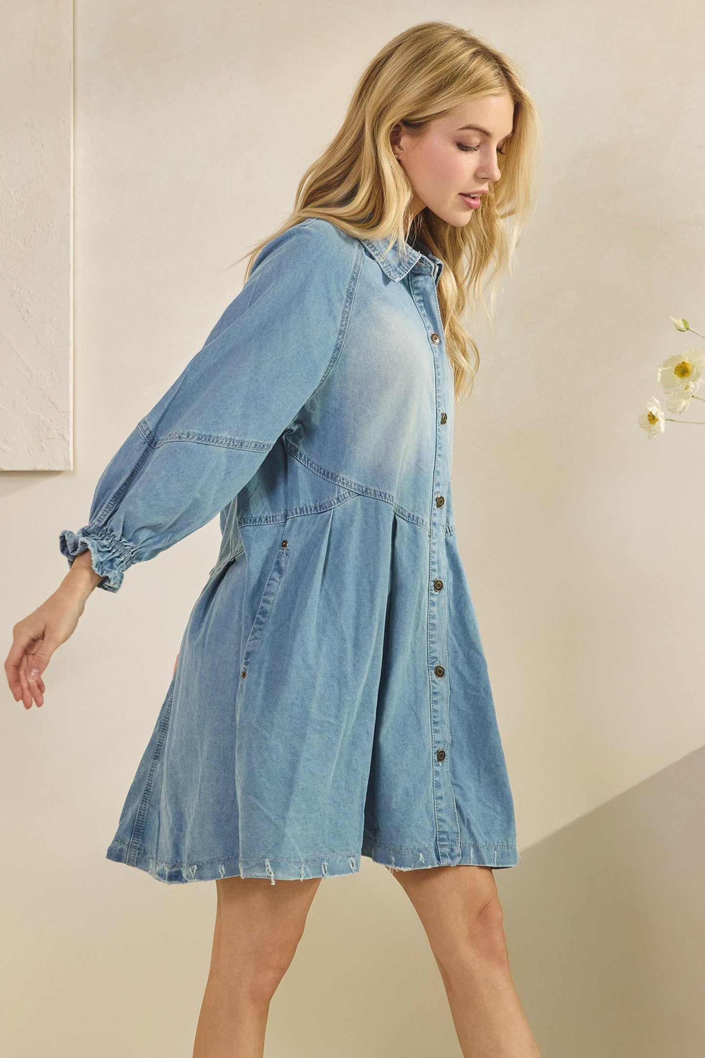 Side angle of the flared A-line denim dress highlighting the relaxed boho-chic fit and construction