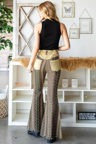 Front view of high-waisted Aztec print flare pants featuring tan corduroy and a 70s retro silhouette.