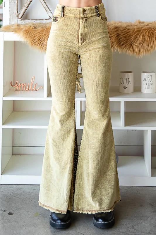 Full-length view of a model wearing tan corduroy Aztec flare pants for an eclectic Western look.
