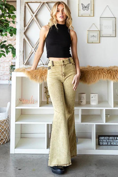 Colorful Southwestern geometric print on vintage-inspired bell bottoms with olive and burgundy tones.
