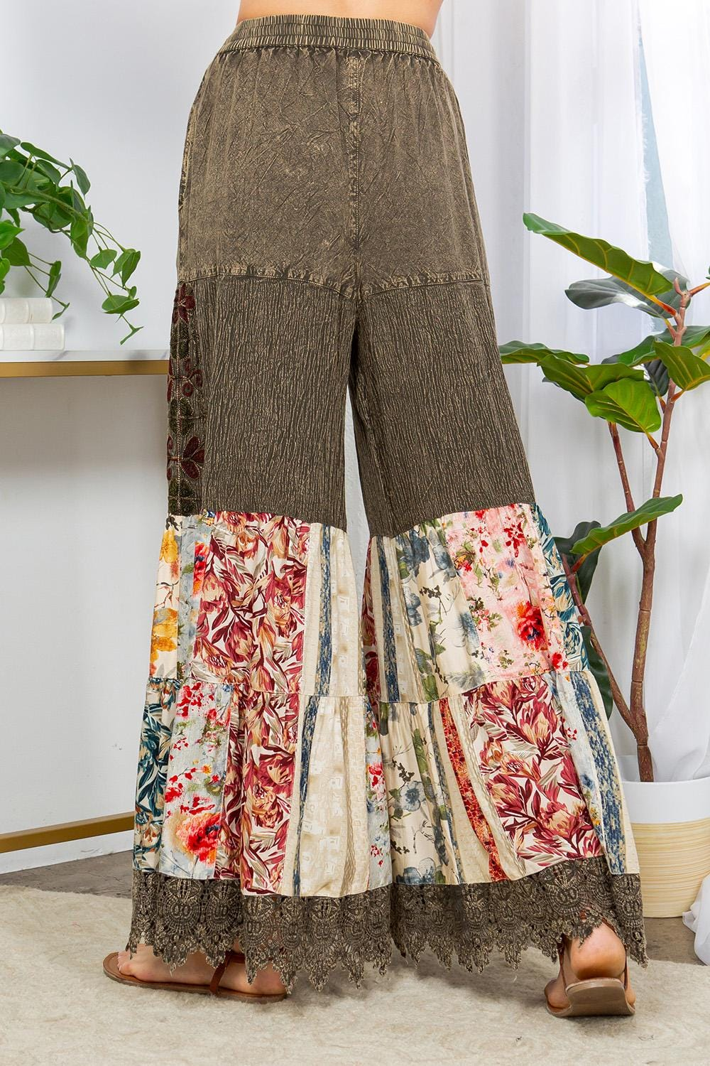 Detailed view of the adjustable drawstring waistband on these high-waisted green bohemian trousers