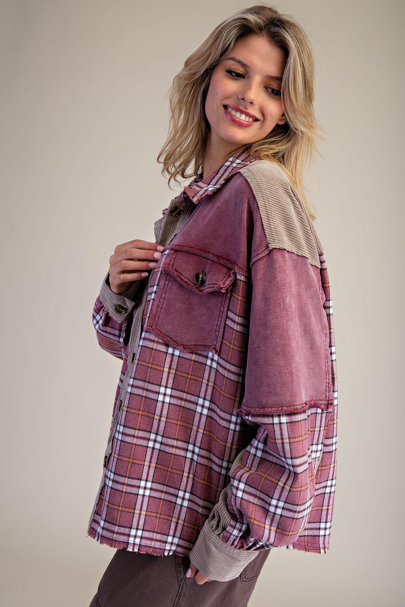 Close-up of the distressed raw-edge detailing and mixed-media corduroy trim on a burgundy plaid flannel jacket