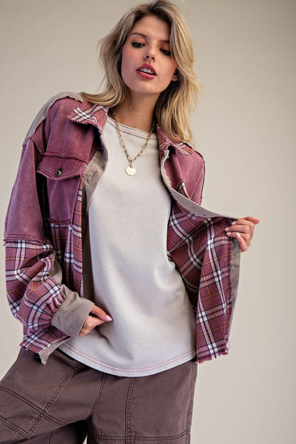 Model wearing a grunge-lite mineral wash plaid shacket for a cozy rustic fall aesthetic at a campfire