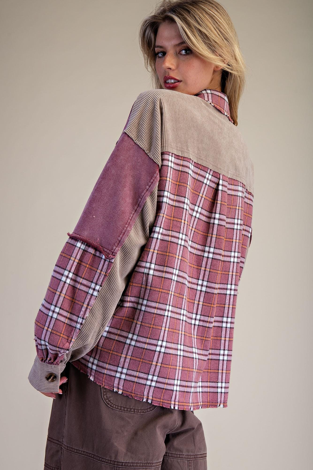 Side angle of a cottagecore-inspired burgundy plaid patchwork shirt jacket layered for cool weather streetwear