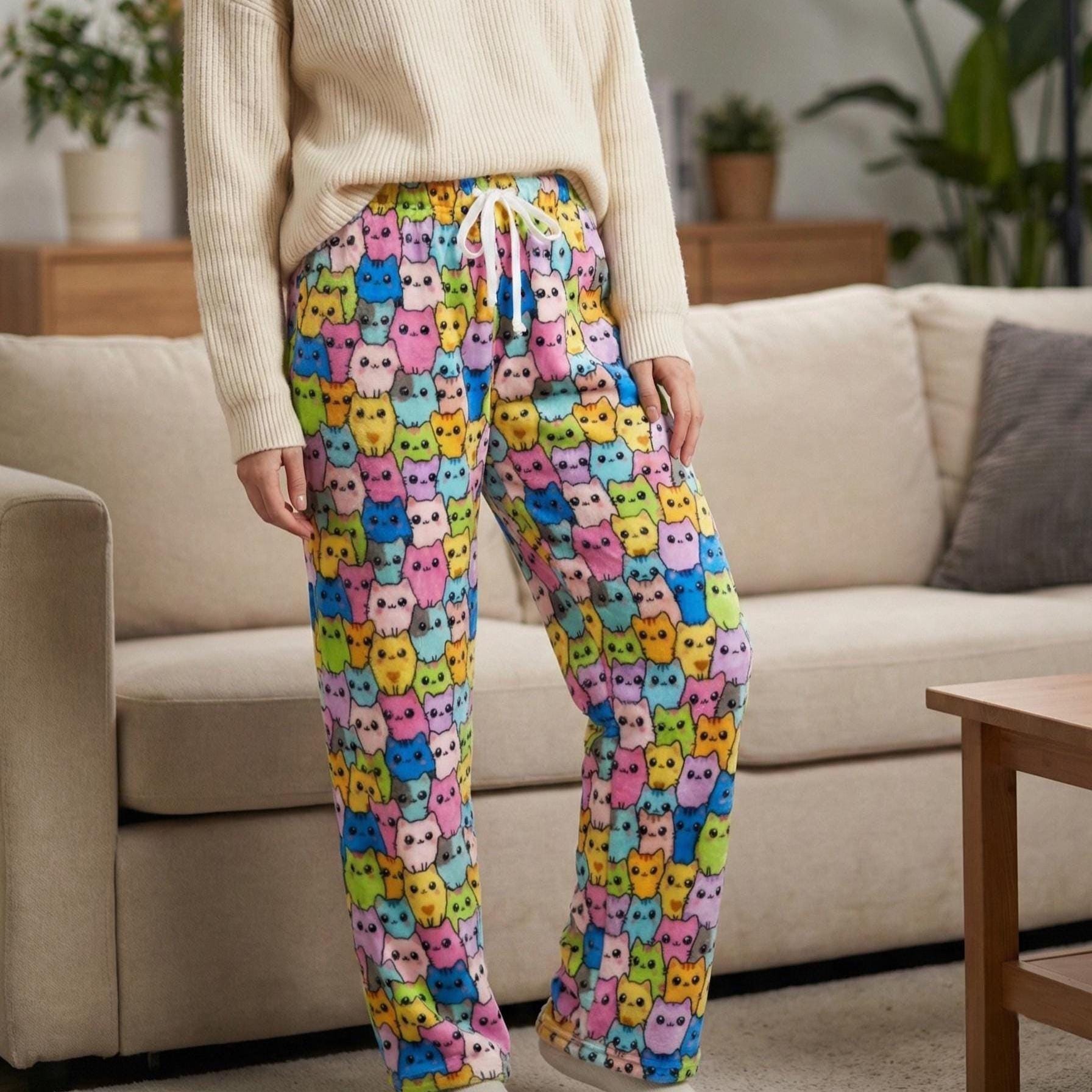 Front view of high waisted cat print pajama pants in vibrant pink and blue plush fleece.