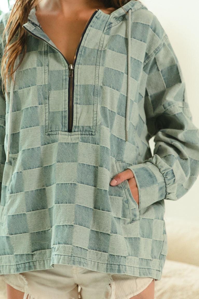 Urban casual outfit featuring a Y2K fashion inspired checkered denim pullover with a unique frayed edge.