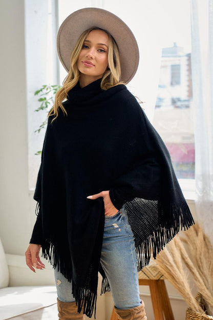 Side profile of the relaxed one-size-fits-most black poncho showcasing its non-bulky silhouette
