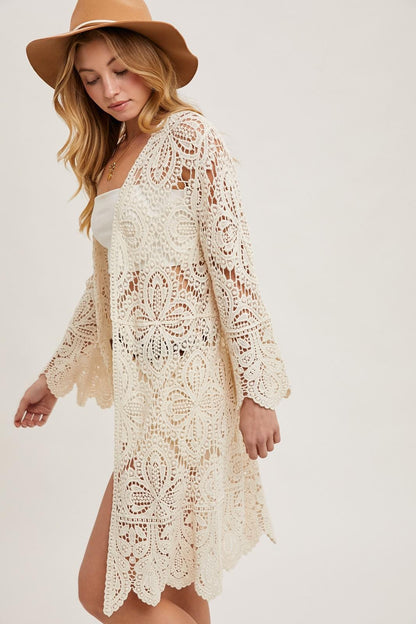 Lifestyle shot of a cottagecore ivory lace duster styled for a romantic golden hour festival look