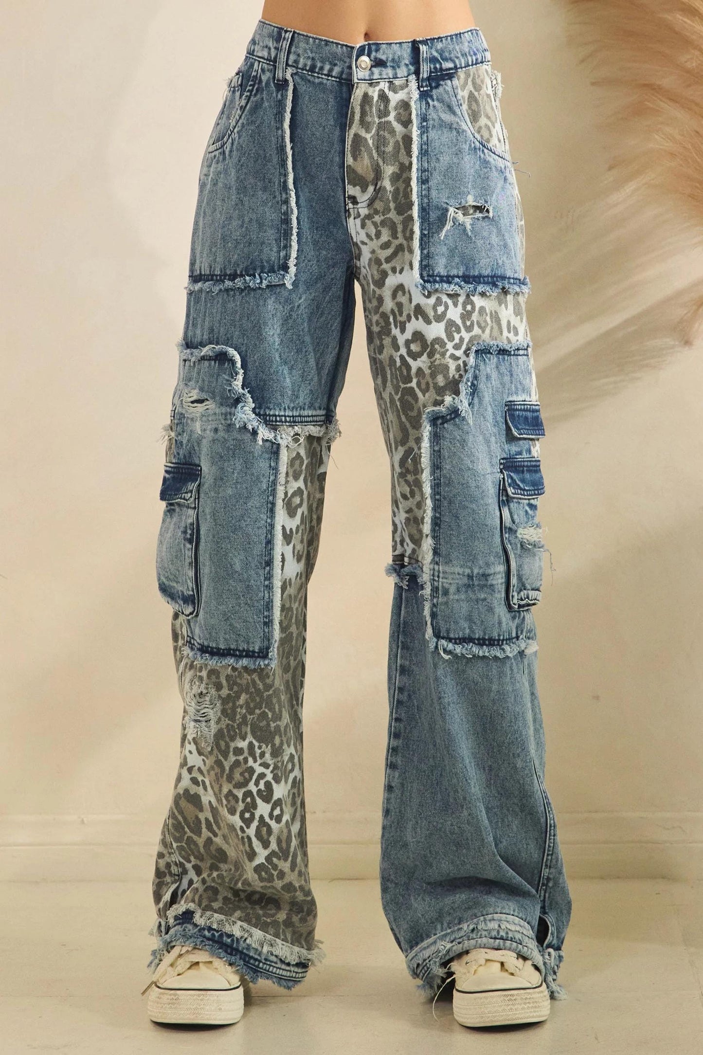 Raw frayed hem and wide-leg silhouette of leopard print cargo denim in blue