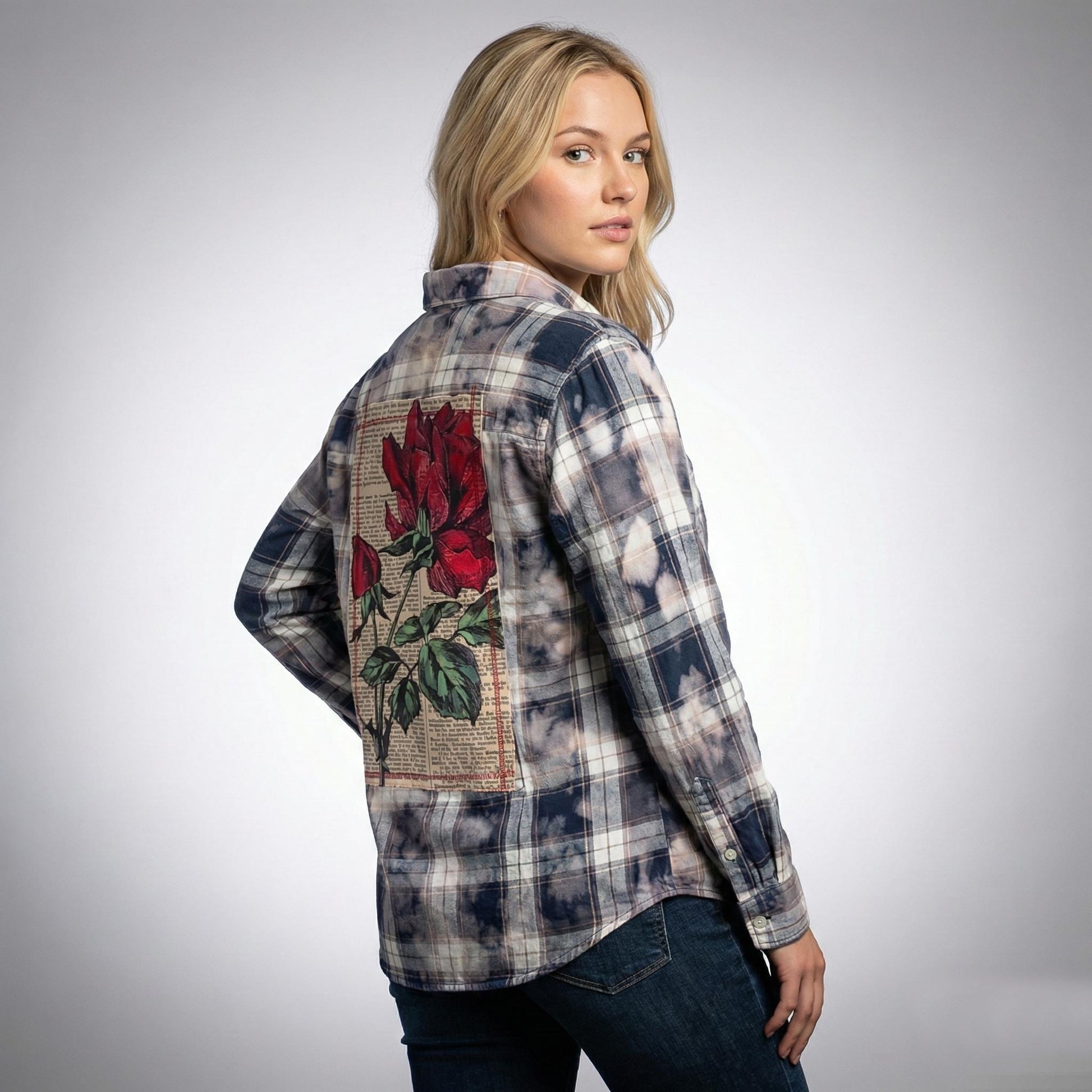 Front view of a navy and cream distressed plaid shirt featuring an oversized fit and frayed hem for a grunge look.