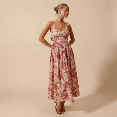 Front view of a red toile floral maxi dress with a corset bodice and basque waist design