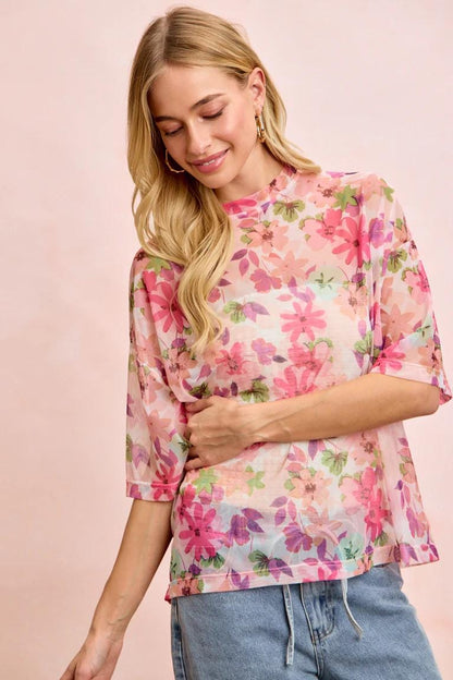Side view of the boxy botanical t-shirt highlighting the airy, oversized silhouette and soft colors