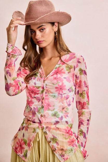Floral mesh V-neck blouse with pink watercolor botanical print, ruched bust, button-down front, pointed hem, and slim long sleeves