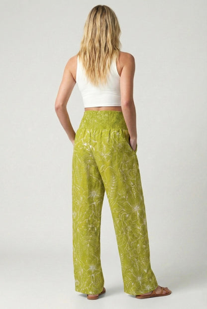 Rear view of lime green floral wide leg 100% linen pants with a smocked waistband and tall fit relaxed silhouette.