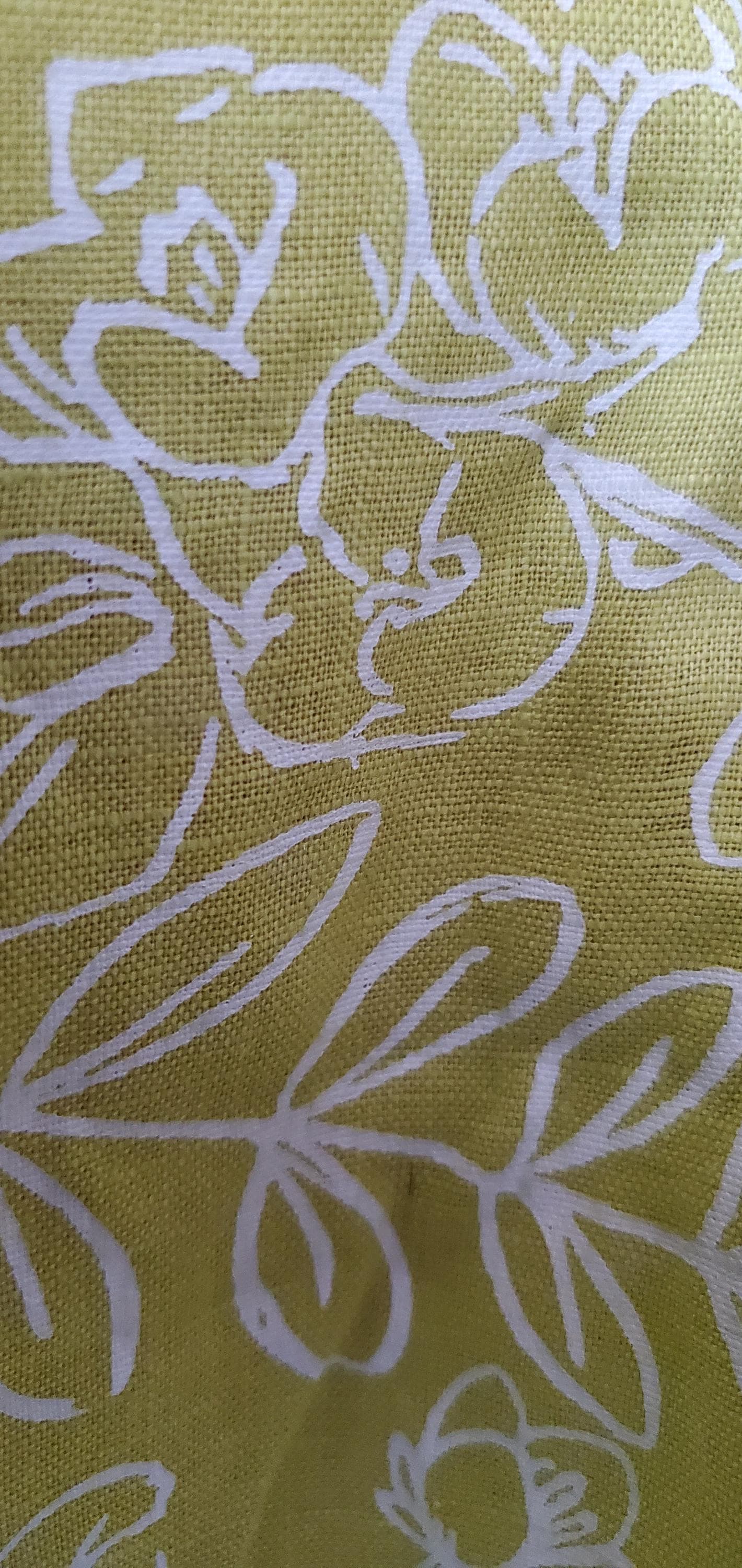 Close-up of the lime green botanical floral print on breathable 100% linen fabric.