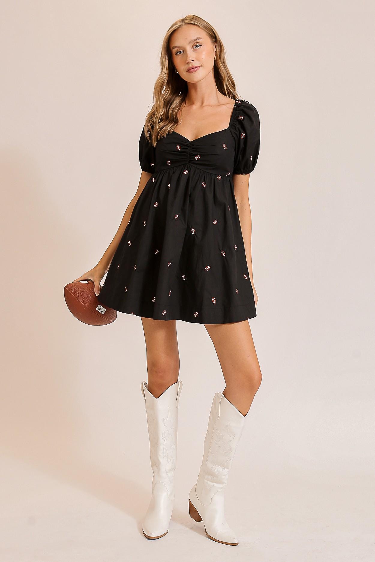 Close-up detail of the brown football pattern and center ruching on this gameday glam babydoll dress