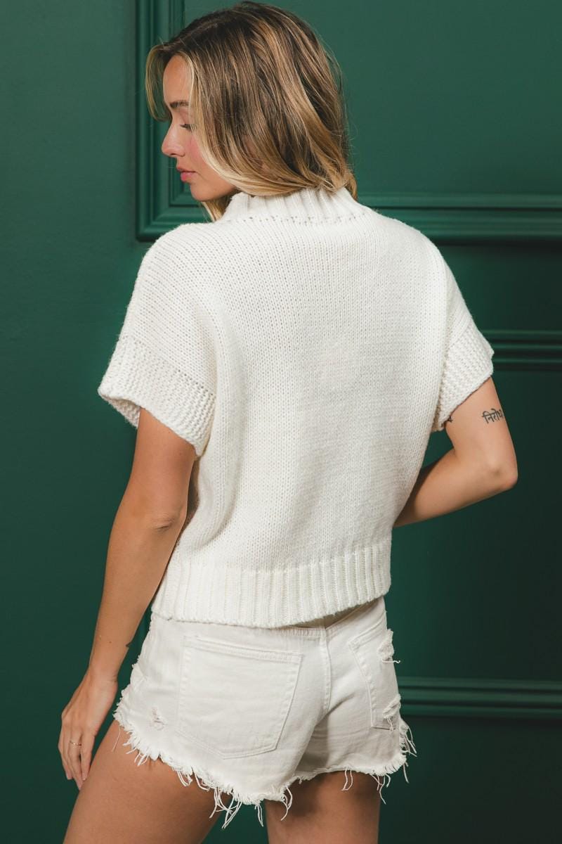 Detail of the ribbed crew neck and short sleeves on this sporty chic football sweater