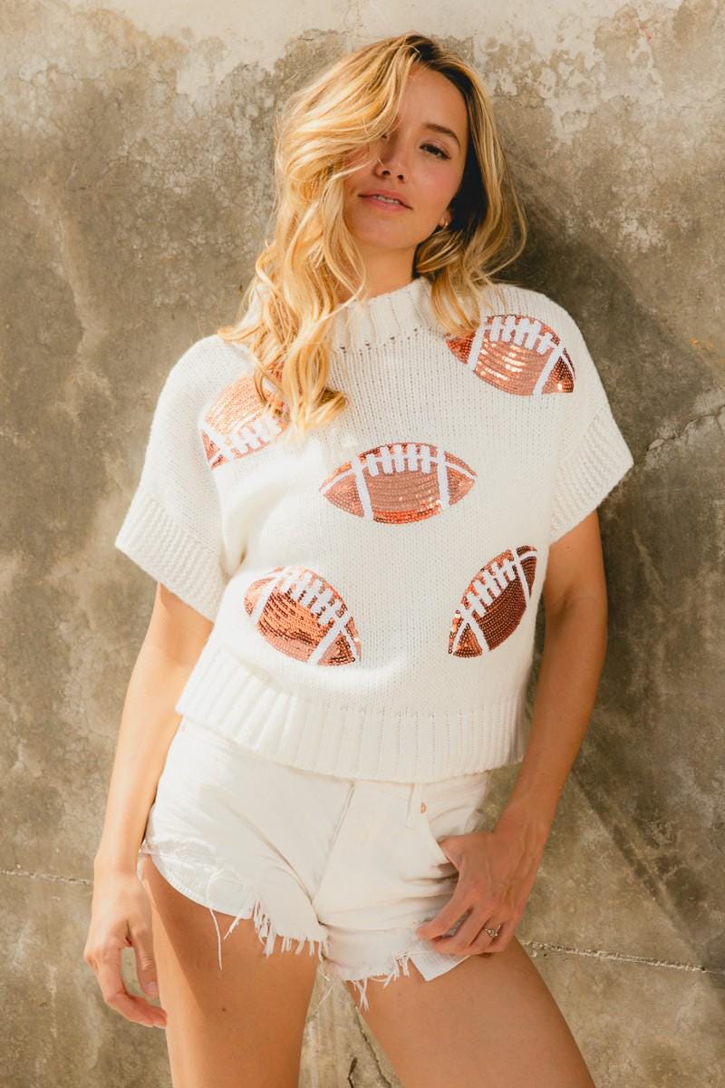 Casual fall fashion outfit featuring a sequin embellished football sweater paired with denim