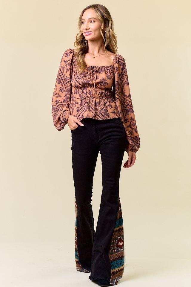Back view of slim-fit bell bottoms in black denim featuring a flattering high-rise cowgirl aesthetic