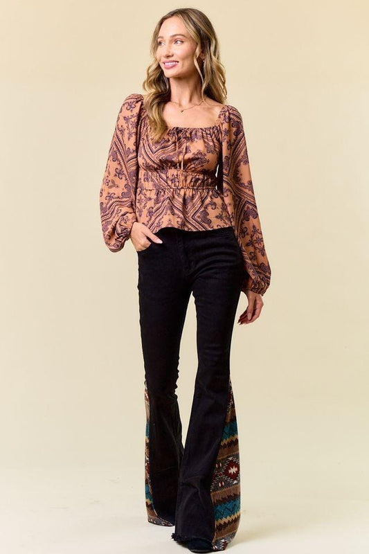Back view of slim-fit bell bottoms in black denim featuring a flattering high-rise cowgirl aesthetic