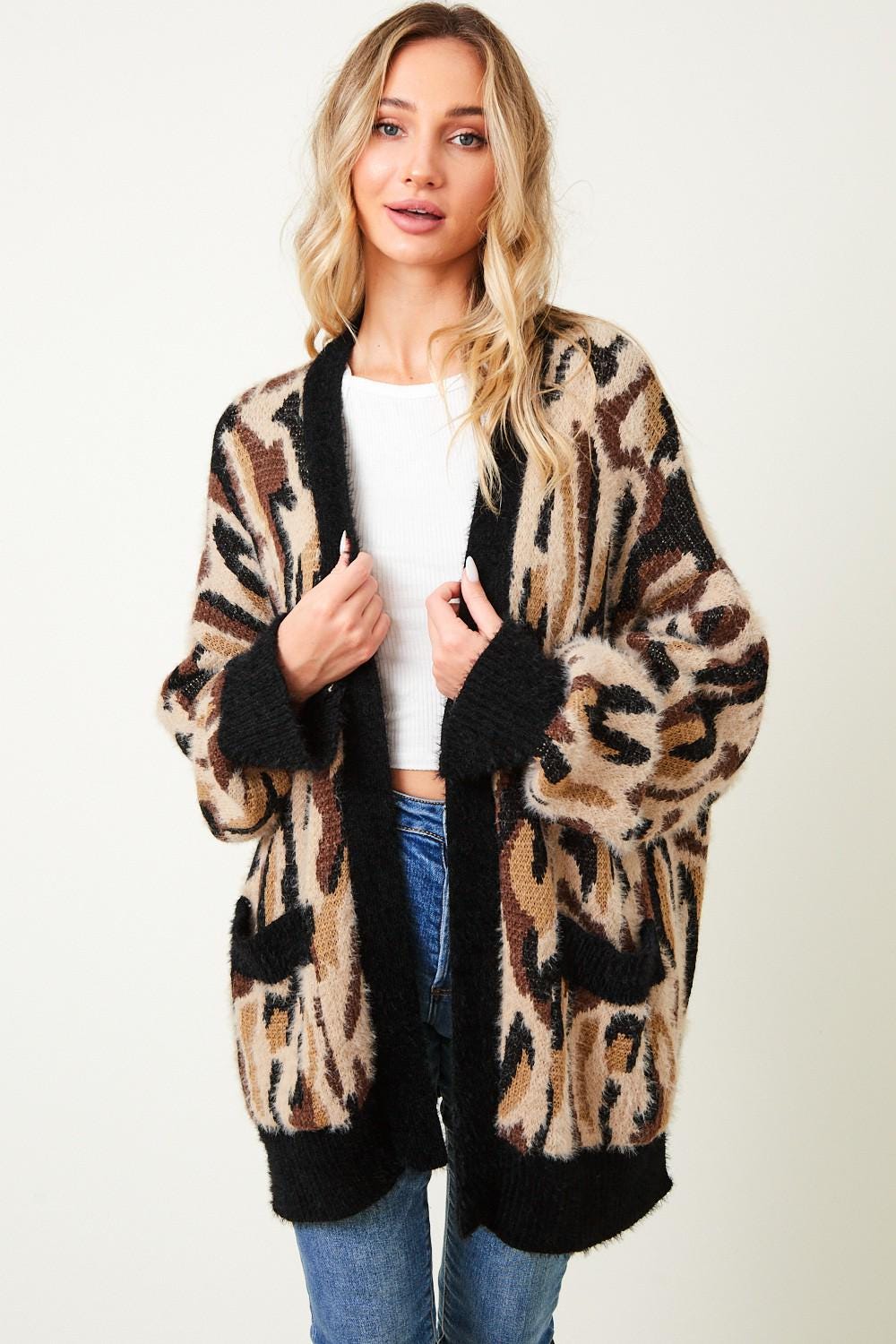 Front view of an oversized leopard print cardigan with a plush eyelash knit texture in tan and black.
