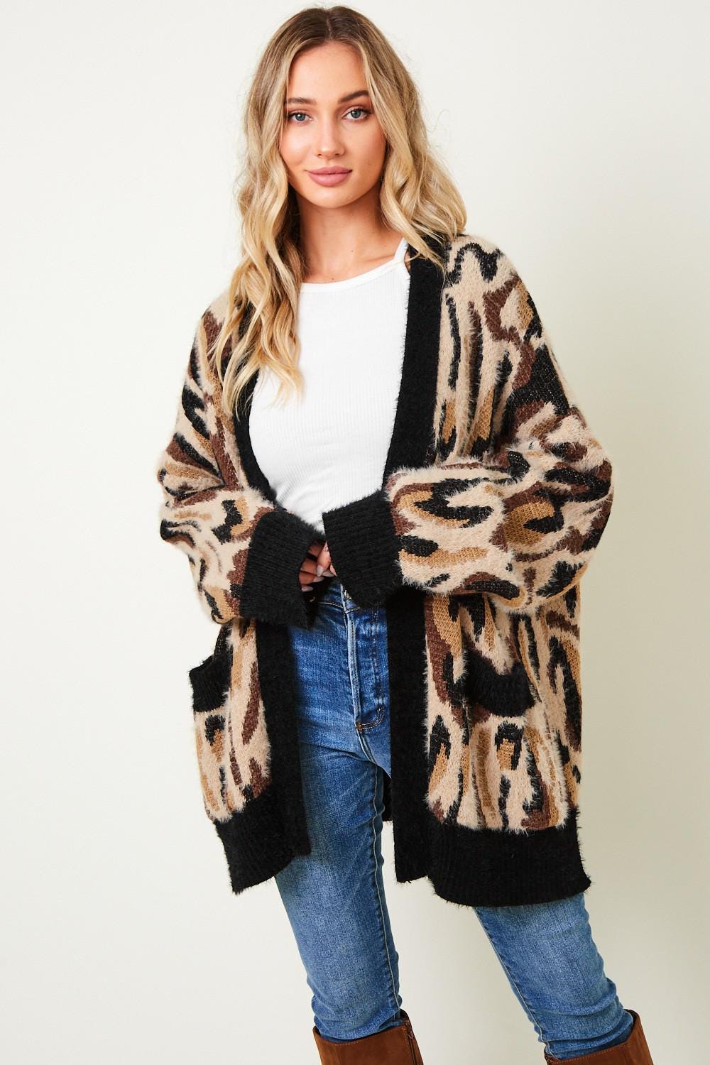 Back view showing the relaxed silhouette of a long animal print fuzzy knit sweater for a mob wife aesthetic.