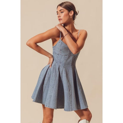 Light wash denim corset mini dress with spaghetti straps and a flared paneled skirt.