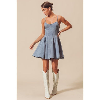 Side view of the light blue flared paneled skirt showing the structured yet airy silhouette