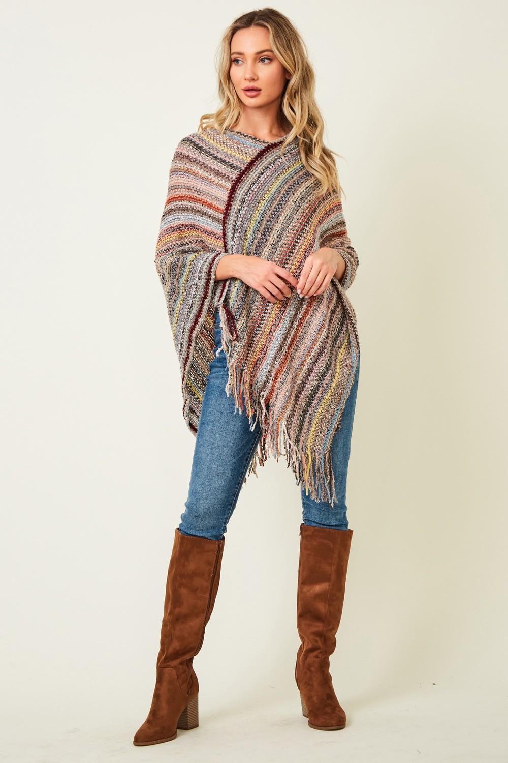 Front view of a multi-color boho poncho in desert sand and rust acrylic knit with a fringed hem.