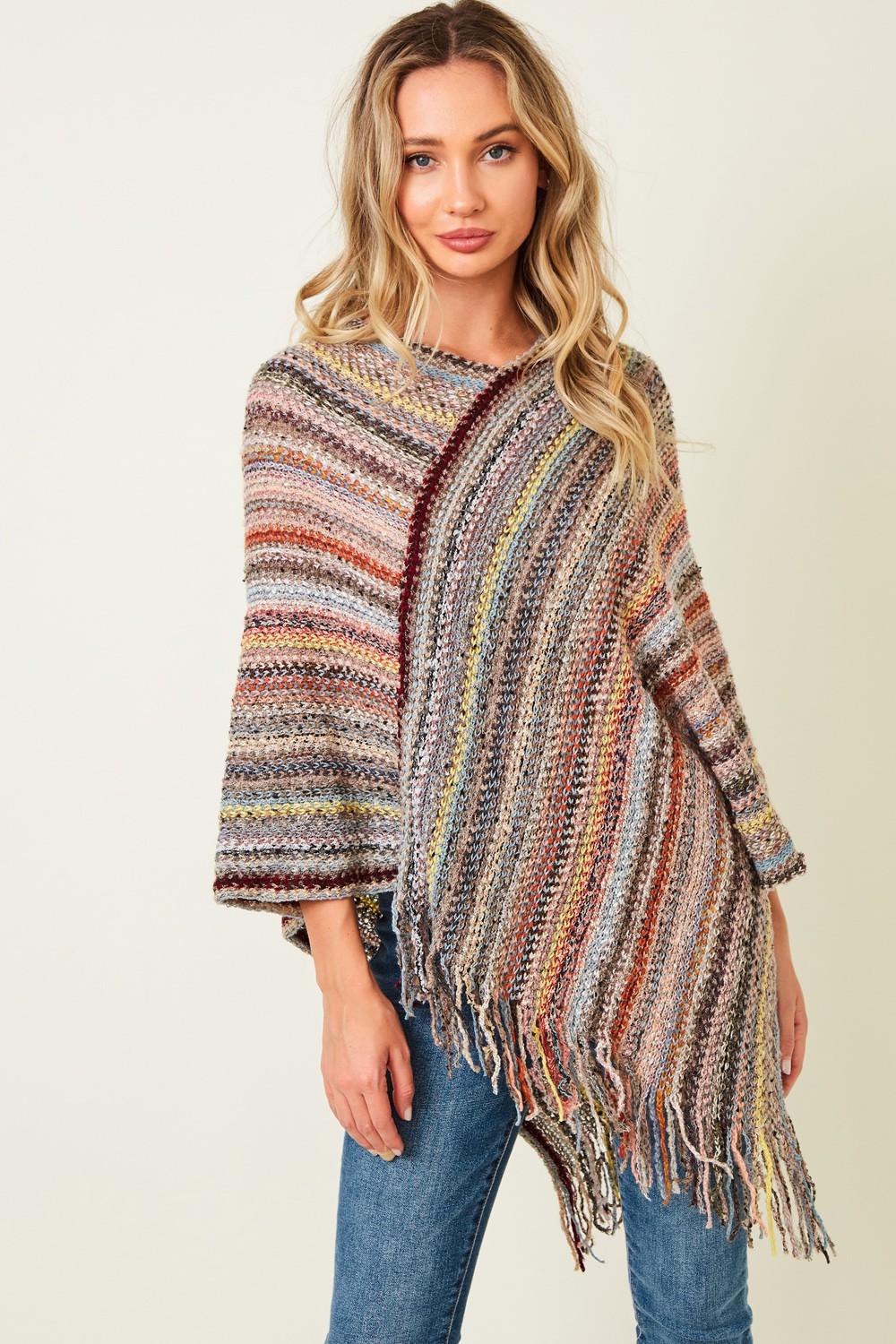 Close-up of the artisanal space-dye knit texture on the multi-color acrylic poncho featuring slate blue and rust.
