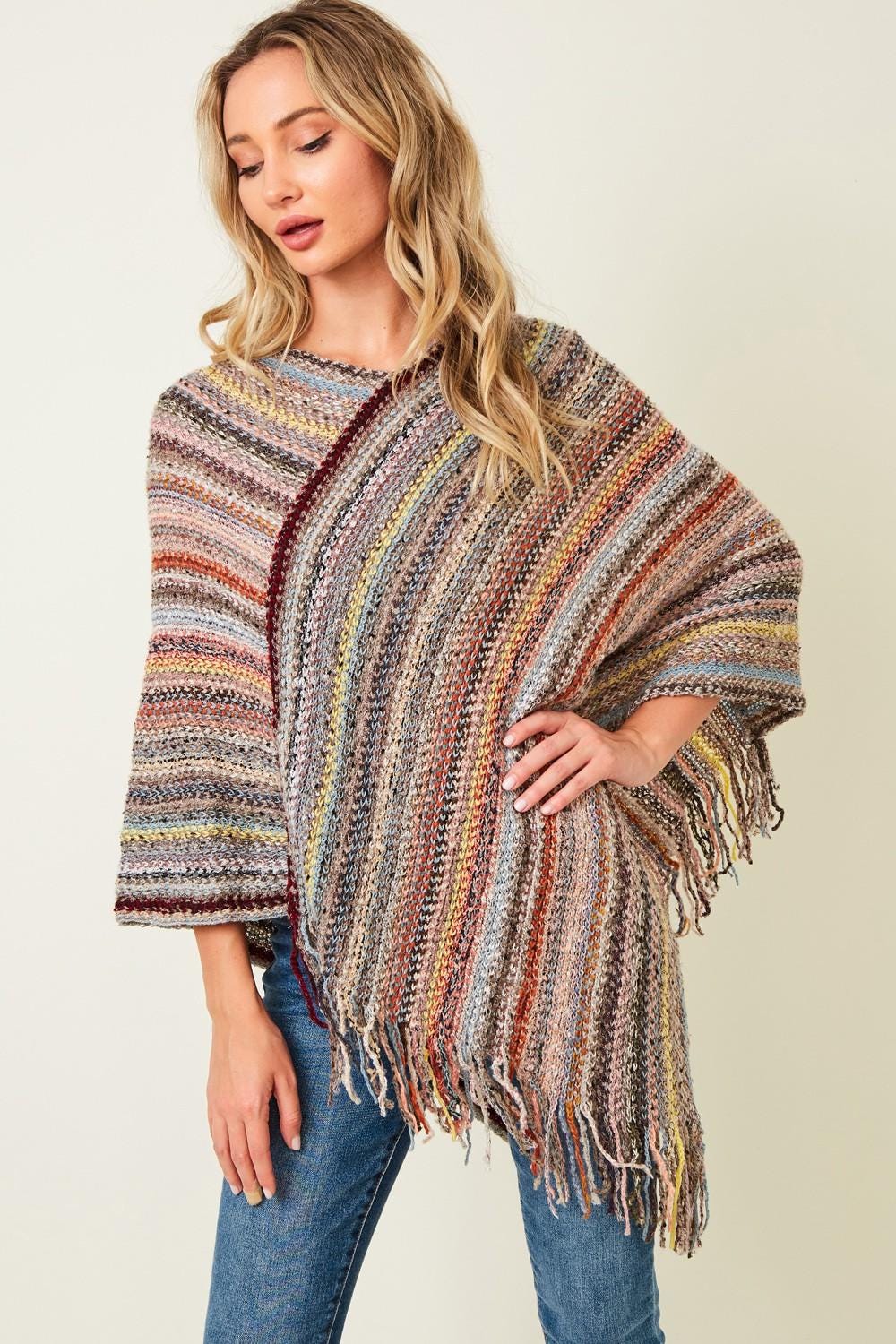 Model wearing the Whimsigoth-inspired fringed wrap as festival outerwear with a coastal cowgirl style.
