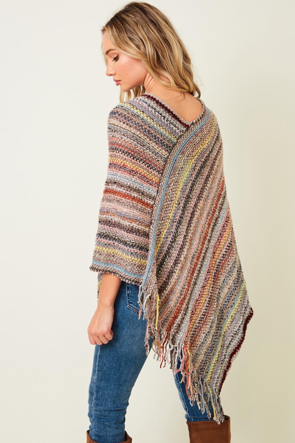 Desert-chic tapestry style wrap shown from a high angle, a versatile earth-toned layering piece for any season.