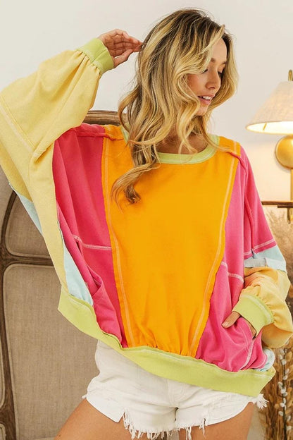 Side view highlighting the comfortable dropped-shoulder silhouette and vibrant lime green patchwork panel.