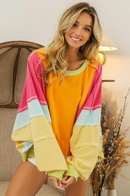 Soft cotton-blend sleeve detail with bright yellow and pink colorblocking and visible stitching on the cuff.