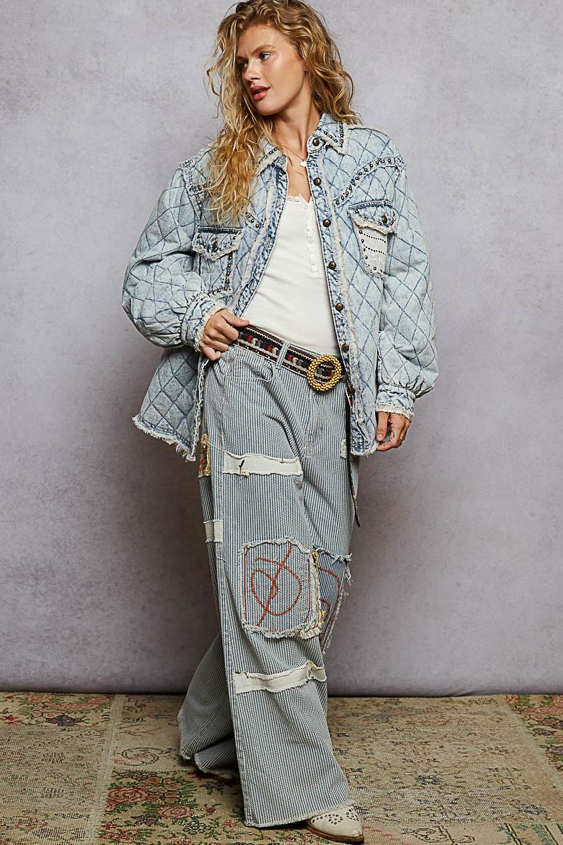 Lifestyle shot of a model wearing a relaxed fit padded denim jacket with feminine lace overlays