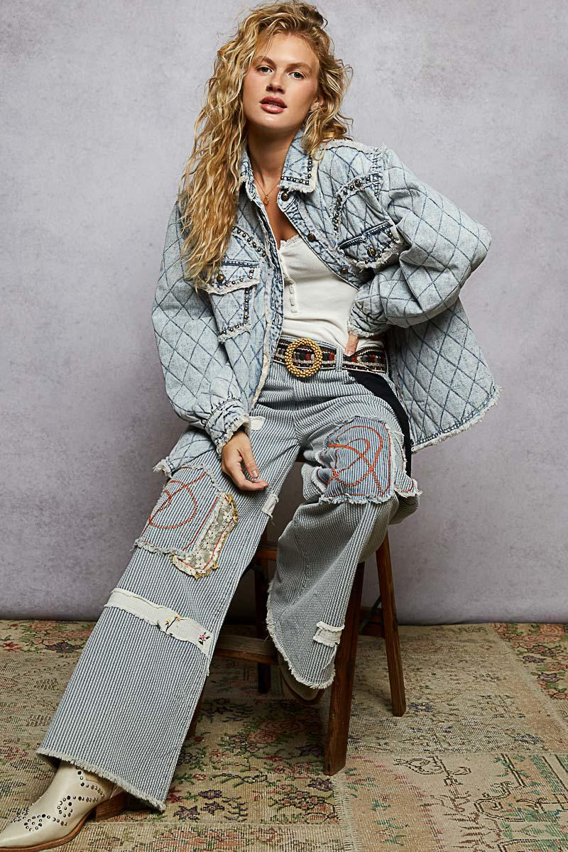 Side profile of a light blue quilted jacket showcasing the oversized silhouette and antique metal buttons