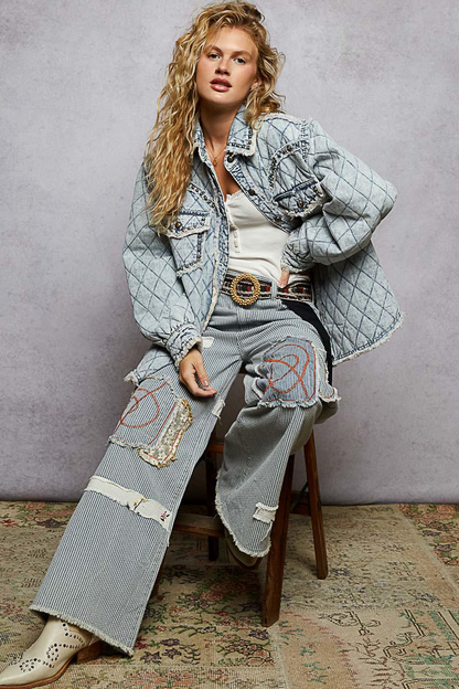 Side profile of a light blue quilted jacket showcasing the oversized silhouette and antique metal buttons