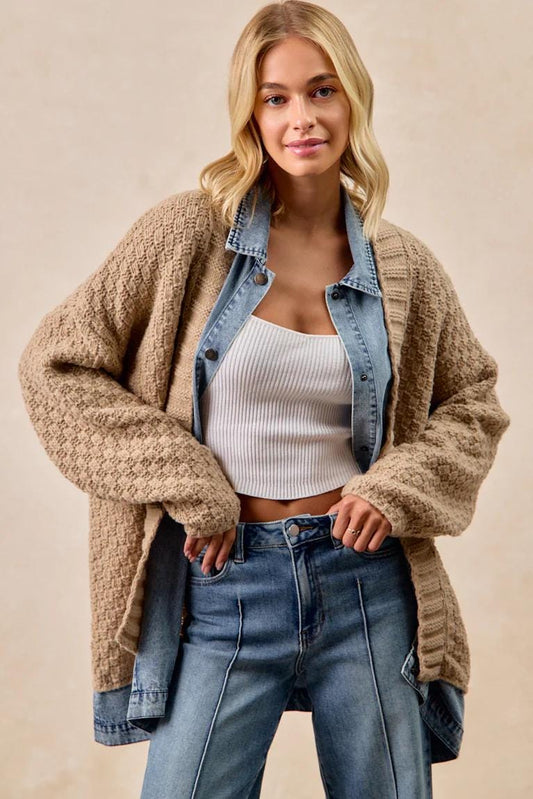 Front view of the oversized waffle knit cardigan with light wash denim patchwork details