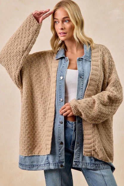 Close-up of the textured waffle knit material on a tan boho-chic mixed-media cardigan