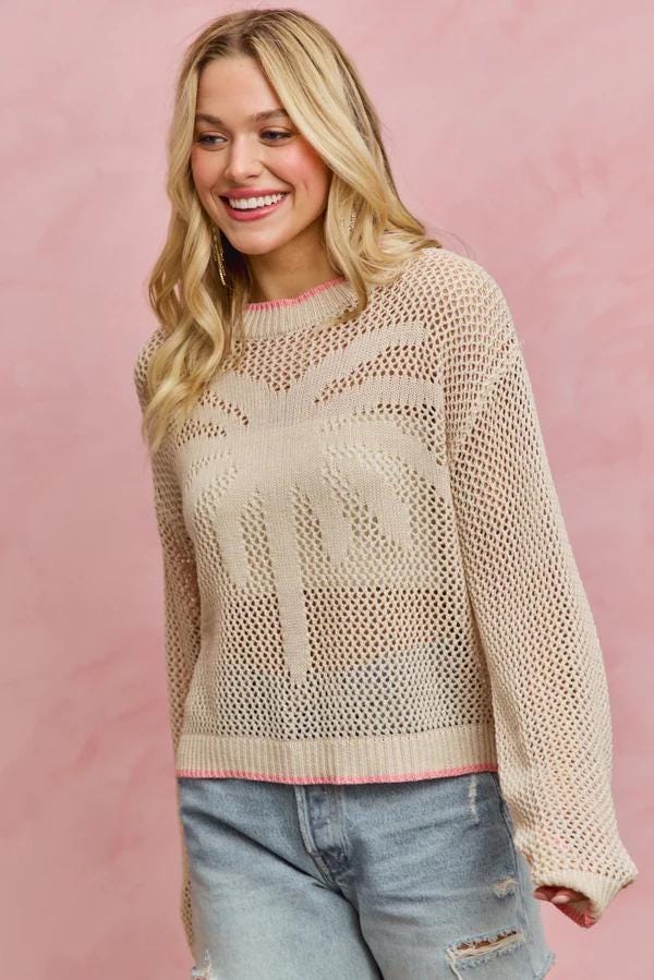 Back profile of the coastal chic beige sweater featuring a breathable open fishnet cotton blend weave.