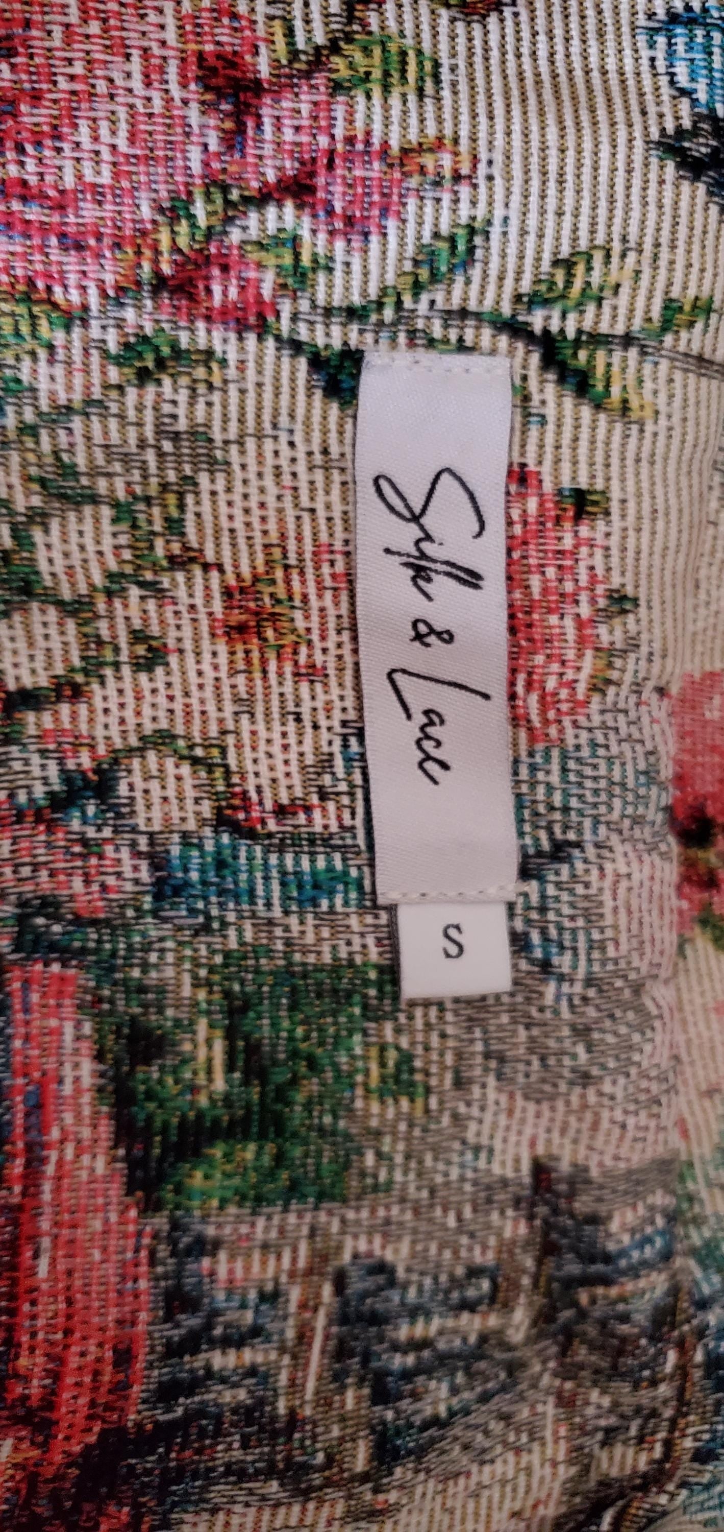 Three-quarter view of the beige and cream French landscape jacket for a vintage-inspired aesthetic