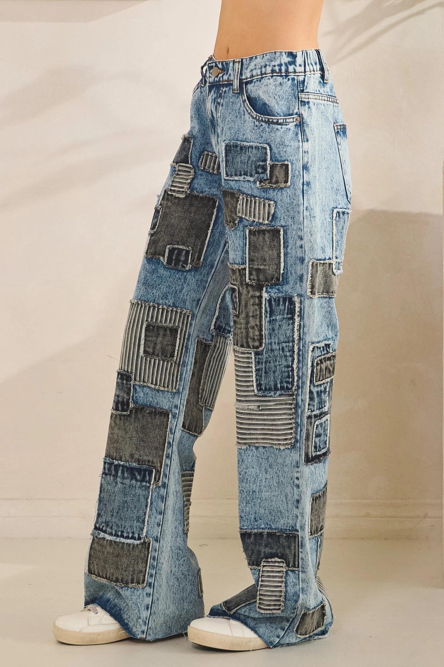 Lifestyle shot of 90s revival patchwork denim pants in motion for a grunge-chic aesthetic