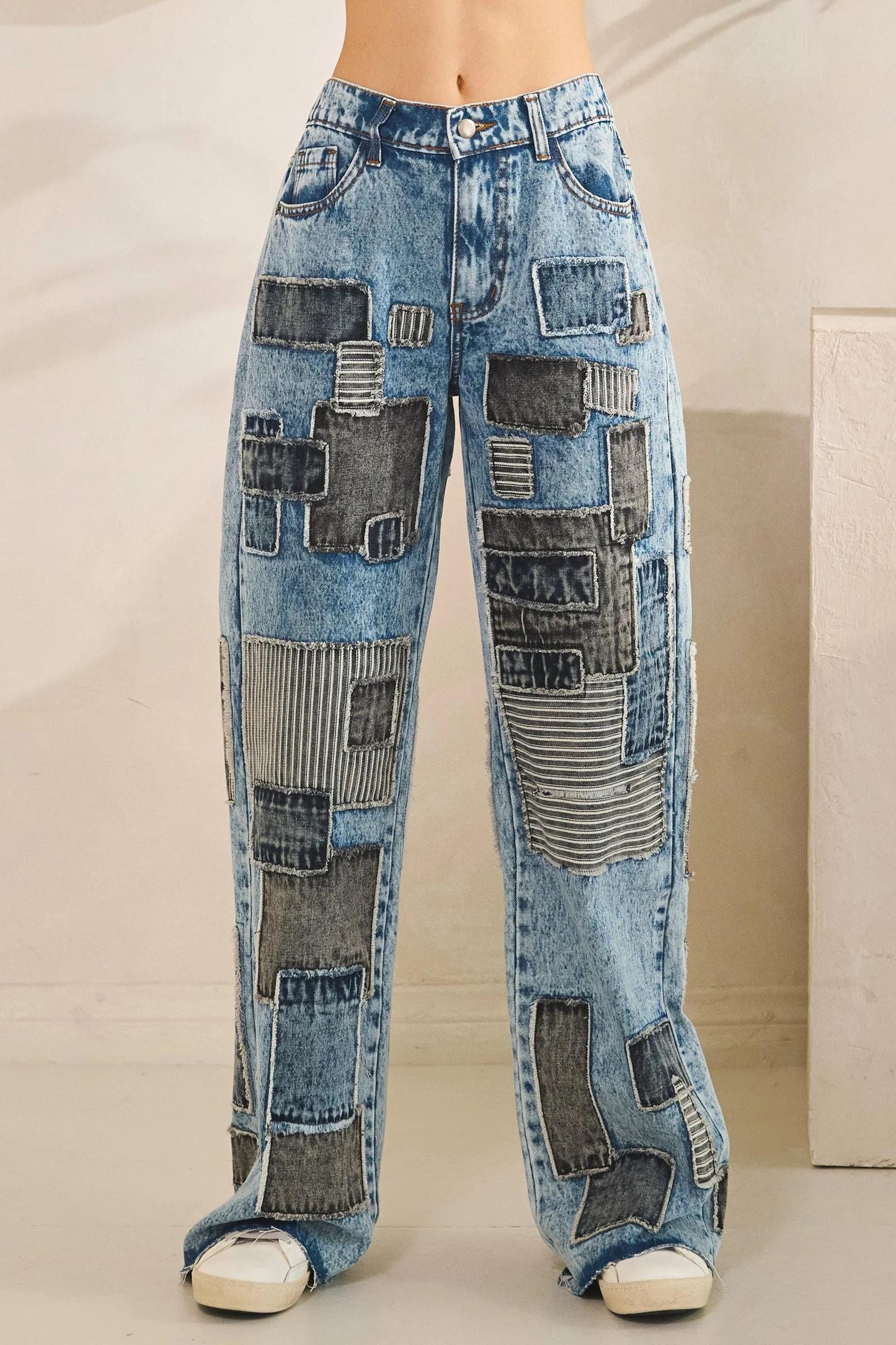 Detail of 100% cotton mineral wash denim with charcoal gray and monochrome striped artisanal accents