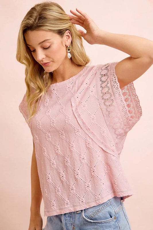 Back profile of this diamond knit shirt showing the intricate floral eyelet patterns and breathable fabric.