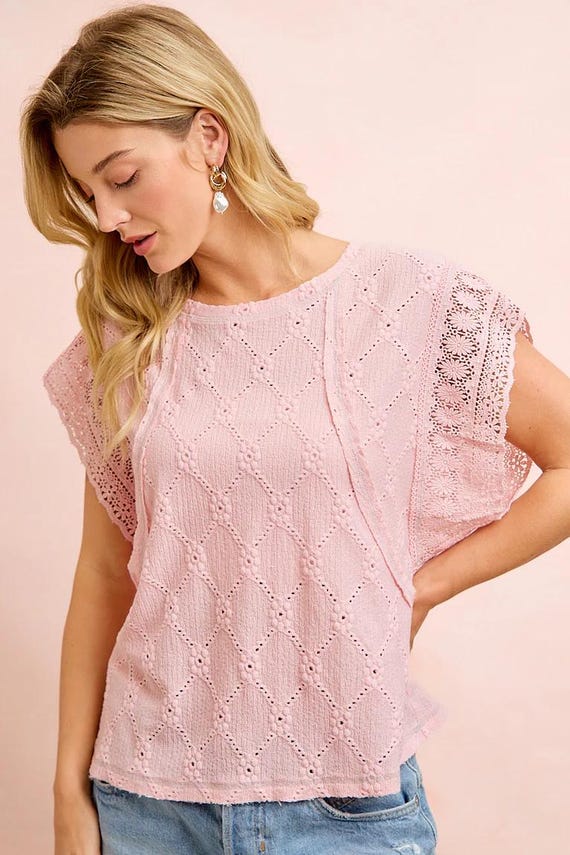 Side perspective of a textured knit shirt showcasing the diamond eyelet knit and relaxed fit.