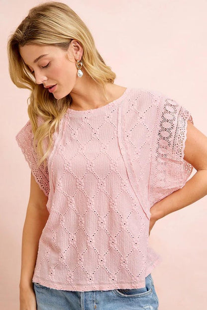 Side perspective of a textured knit shirt showcasing the diamond eyelet knit and relaxed fit.