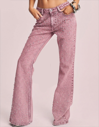 Front view of pink flare jeans with rhinestone embellishments and a wide-leg acid-wash denim finish